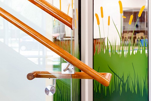 Structural Glass Railing with Wood Top Cap by Hollaender
